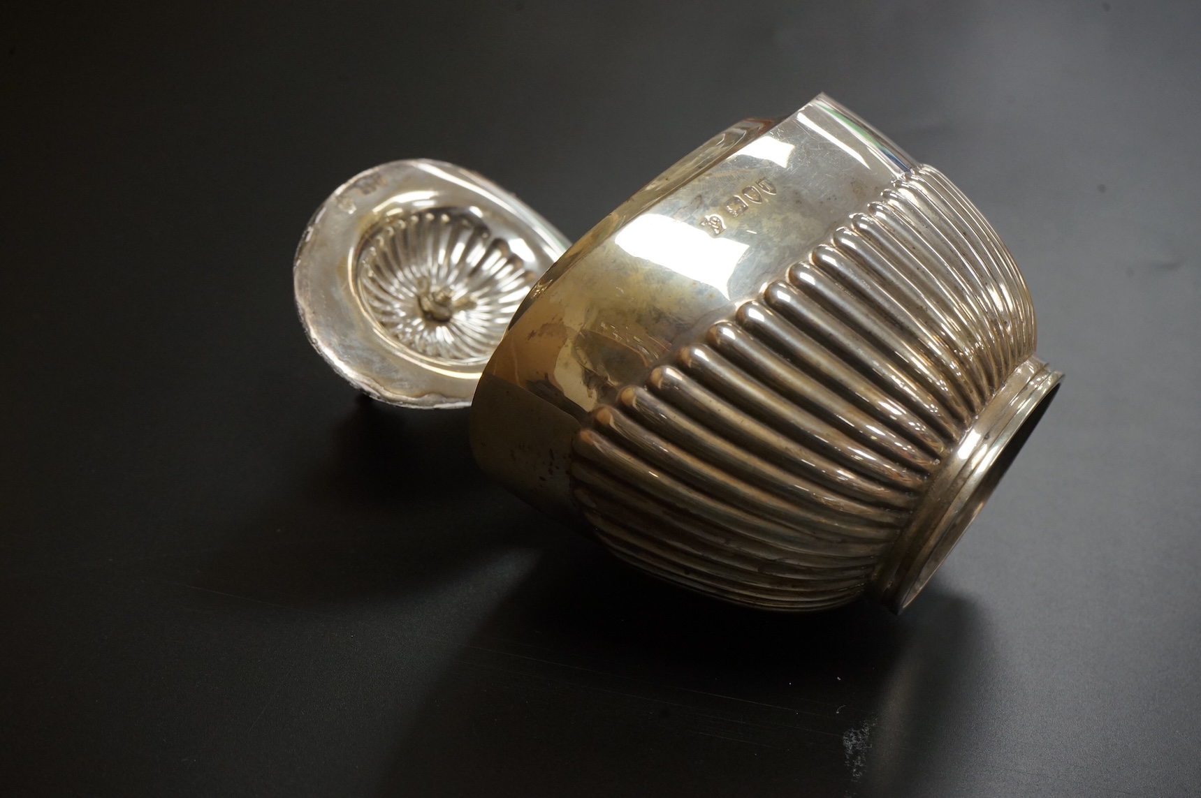 A late Victorian demi-fluted oval tea caddy, by William Hutton & Sons, London, 1894, width 11.1cm, together with a 19th century continental white metal oval tea caddy, possibly French, no key.